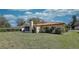 Charming single-story home with a red tile roof and a well-manicured lawn at 1450 Highfield Dr, Clearwater, FL 33764
