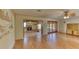 Open-concept living area with hardwood floors, fireplace and access to a screened patio through French doors at 1450 Highfield Dr, Clearwater, FL 33764