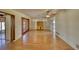 Open-concept living room with wood floors and a decorative cabinet offers lots of natural light at 1450 Highfield Dr, Clearwater, FL 33764
