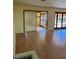 Bright living room features wood floors and sliding glass doors to bring the outdoors in at 1450 Highfield Dr, Clearwater, FL 33764