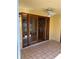 Covered patio with tile flooring and wood-framed sliding glass doors and ceiling fan at 1450 Highfield Dr, Clearwater, FL 33764