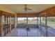 Screened porch with tile floor, ceiling fan, and sliding doors leading to the backyard at 1450 Highfield Dr, Clearwater, FL 33764