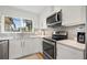 This kitchen offers stainless steel appliances, plenty of counter space, and bright white cabinets and countertops at 1472 47Th Ne Ave, St Petersburg, FL 33703