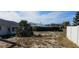 A well-maintained backyard with mature trees and a privacy fence at 1507 N Lake Dr, Sun City Center, FL 33573