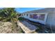 Well maintained backyard with a small patio surrounded by landscaping at 1507 N Lake Dr, Sun City Center, FL 33573