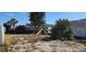 Lush, green yard with mature trees and plants surrounding this charming home at 1507 N Lake Dr, Sun City Center, FL 33573