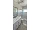 Bathroom features a vanity, mirror with decorative tile and glass enclosed shower at 1507 N Lake Dr, Sun City Center, FL 33573