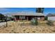 Charming brick home featuring desert-style landscaping and a covered carport at 1507 N Lake Dr, Sun City Center, FL 33573
