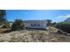 A cozy home is surrounded by mature trees and greenery in a peaceful setting at 1507 N Lake Dr, Sun City Center, FL 33573