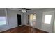This is a large living room with hardwood floors and access to the backyard through a sliding glass door at 1507 N Lake Dr, Sun City Center, FL 33573