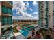 Aerial view showcases the community's pool, tennis courts and landscaping with water views at 1520 Gulf Blvd # 805, Clearwater Beach, FL 33767