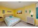 Sunny yellow bedroom features a cozy bed, beach-themed decor, and modern furniture at 1520 Gulf Blvd # 805, Clearwater Beach, FL 33767