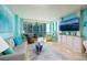 Bright living room with a sliding door to balcony, comfortable seating, and modern decor with turquoise walls at 1520 Gulf Blvd # 805, Clearwater Beach, FL 33767