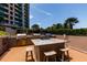 Outdoor grilling area with granite countertop, barstools, and multiple grills for residents at 1520 Gulf Blvd # 805, Clearwater Beach, FL 33767