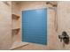 Tiled shower features blue accent tile and a corner seat with open shelving at 1520 Gulf Blvd # 805, Clearwater Beach, FL 33767