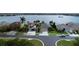 Aerial view of a quiet neighborhood with well-maintained lawns, mature trees, and access to a serene lake at 1648 Mira Lago Cir, Ruskin, FL 33570