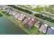 Aerial view of a home with backyard pool located on a waterfront property at 1648 Mira Lago Cir, Ruskin, FL 33570