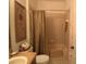 Bathroom featuring tile flooring, a shower with tan curtain, and a decorative palm tree print at 1648 Mira Lago Cir, Ruskin, FL 33570