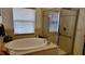 Bright bathroom featuring a soaking tub and glass shower, with a neutral color scheme at 1648 Mira Lago Cir, Ruskin, FL 33570