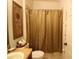 Bathroom featuring tile flooring, a shower with tan curtain, and a decorative palm tree print at 1648 Mira Lago Cir, Ruskin, FL 33570