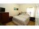 Cozy bedroom with patterned bedding, matching furniture and natural light at 1648 Mira Lago Cir, Ruskin, FL 33570