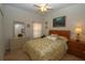 Comfortable bedroom with yellow floral bedding, a ceiling fan, and large sunny window at 1648 Mira Lago Cir, Ruskin, FL 33570