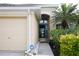 Inviting entryway with a glass front door, a well-maintained lawn and an attached two-car garage at 1648 Mira Lago Cir, Ruskin, FL 33570