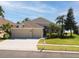 Charming home featuring a well-manicured lawn, a spacious three-car garage and beautiful landscaping at 1648 Mira Lago Cir, Ruskin, FL 33570