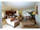 Open-concept living room with sofas, neutral tones, and seamless flow to the kitchen at 1648 Mira Lago Cir, Ruskin, FL 33570