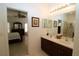 Main bathroom featuring double sinks, a large mirror, and access to the bedroom at 1648 Mira Lago Cir, Ruskin, FL 33570