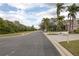 Quiet residential street showcasing sidewalks, lush landscaping, and mature trees at 1648 Mira Lago Cir, Ruskin, FL 33570