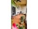 Cozy screened patio featuring red tile flooring, comfortable chairs, and lush greenery for tranquil outdoor living at 1648 Mira Lago Cir, Ruskin, FL 33570