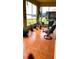 Charming screened patio features red tile flooring, comfortable seating, and garden views for outdoor relaxation at 1648 Mira Lago Cir, Ruskin, FL 33570