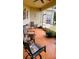 Inviting patio with red tile flooring, comfortable seating, and views of the serene outdoor space at 1648 Mira Lago Cir, Ruskin, FL 33570