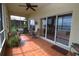 Spacious covered patio with tile flooring, ceiling fan, and sliding doors leading to backyard and lake views at 1648 Mira Lago Cir, Ruskin, FL 33570