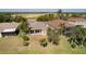 Rear aerial view of a beautiful single-Gathering home with a screened-in patio and lush green landscaping at 1648 Mira Lago Cir, Ruskin, FL 33570