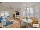 Staged living room with comfortable seating and a dining area showcasing natural light and modern decor at 1685 Fry Ct, Dunedin, FL 34698