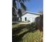 Backyard with a partial view of the pool, house, and wooden fence at 1982 Seton Dr, Clearwater, FL 33763