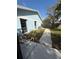 Spacious backyard showcasing the home's light blue exterior and a concrete patio at 1982 Seton Dr, Clearwater, FL 33763