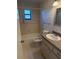 A full bathroom featuring a tub and shower combination, tiled walls and updated vanity at 1982 Seton Dr, Clearwater, FL 33763