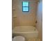 Full bathroom with tub and shower combination features tiled walls and window at 1982 Seton Dr, Clearwater, FL 33763