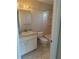 Tiled bathroom features vanity, mirror, and tub/shower combination at 1982 Seton Dr, Clearwater, FL 33763