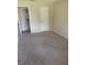 Bedroom boasts neutral paint and carpeting with windows and access to the kitchen at 1982 Seton Dr, Clearwater, FL 33763