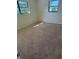 A carpeted bedroom with two windows providing natural light at 1982 Seton Dr, Clearwater, FL 33763
