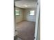 A cozy bedroom with two windows providing natural light and wall to wall carpeting at 1982 Seton Dr, Clearwater, FL 33763