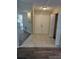 Foyer featuring tile flooring, a mirrored wall, and a view into the kitchen and living spaces at 1982 Seton Dr, Clearwater, FL 33763