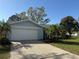 The home has an attached two-car garage, mature landscaping, and a well-maintained yard at 1982 Seton Dr, Clearwater, FL 33763