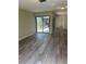 The spacious living room features modern flooring and access to the patio through sliding doors at 1982 Seton Dr, Clearwater, FL 33763