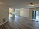 The living room has wood-look floors, neutral paint, and sliding glass doors to the outdoor screened area at 1982 Seton Dr, Clearwater, FL 33763