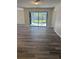 Spacious living area with modern flooring and sliding glass doors leading to a screened porch at 1982 Seton Dr, Clearwater, FL 33763